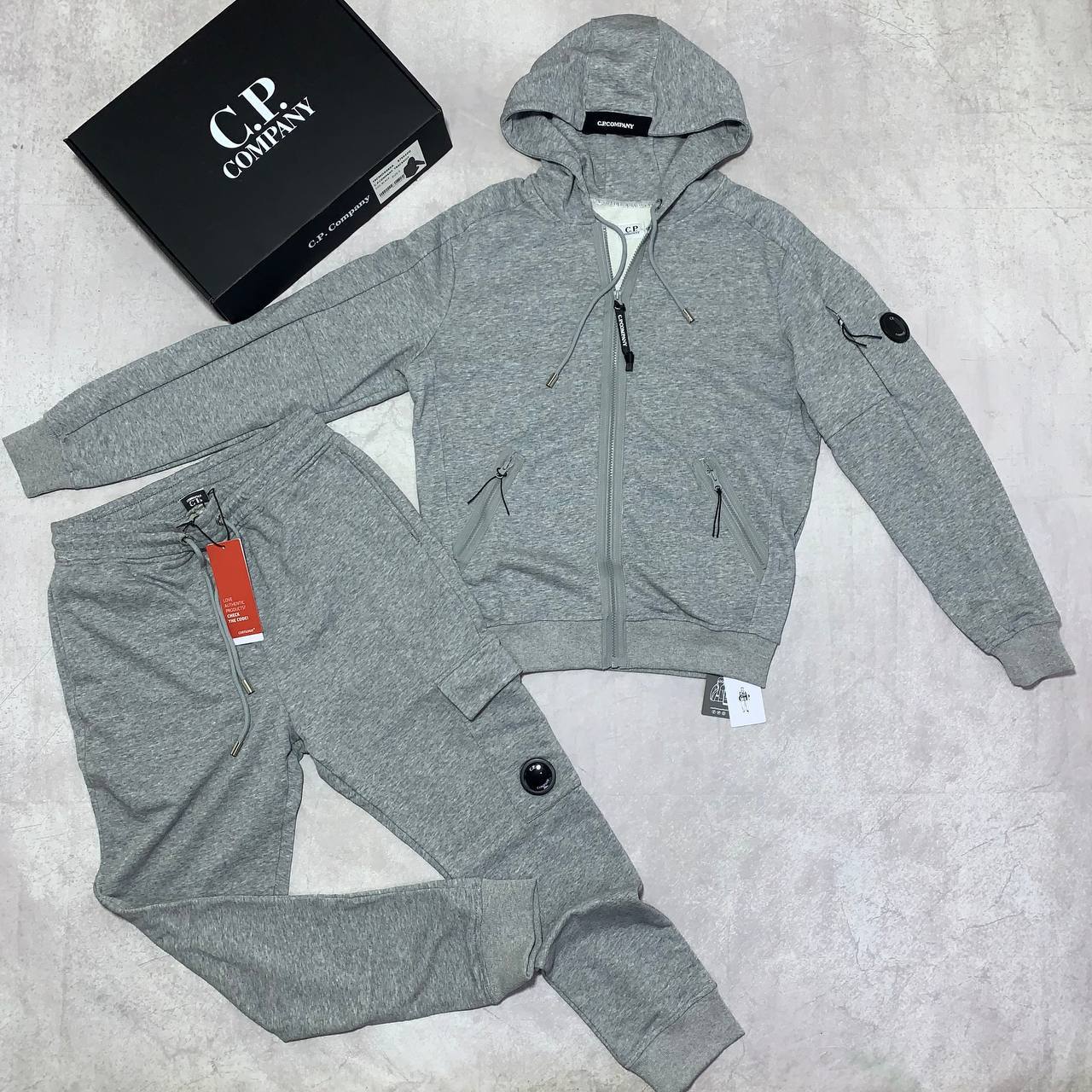 C.P. Company Diagonal Raised Fleece Full-Zip Tracksuit Featuring Goggle Hoodie and Matching Sweatpants with brand's Signature "Lens" Detail on a Sleeve & Pocket