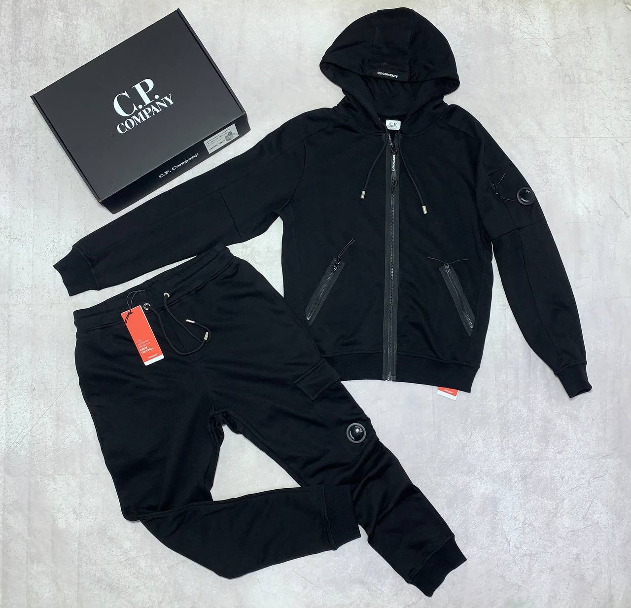 C.P. Company Diagonal Raised Fleece Full-Zip Tracksuit Featuring Goggle Hoodie and Matching Sweatpants with brand's Signature "Lens" Detail on a Sleeve & Pocket