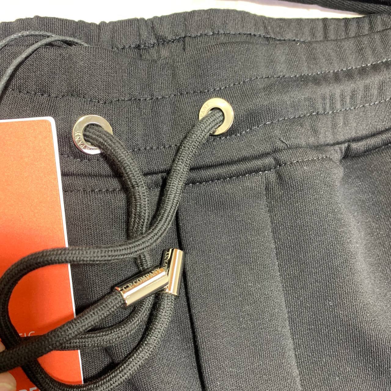 C.P. Company Diagonal Raised Fleece Full-Zip Tracksuit Featuring Goggle Hoodie and Matching Sweatpants with brand's Signature "Lens" Detail on a Sleeve & Pocket