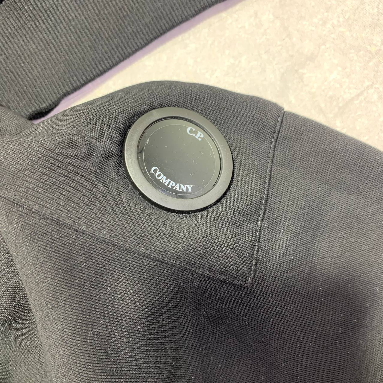 C.P. Company Diagonal Raised Fleece Full-Zip Tracksuit Featuring Goggle Hoodie and Matching Sweatpants with brand's Signature "Lens" Detail on a Sleeve & Pocket