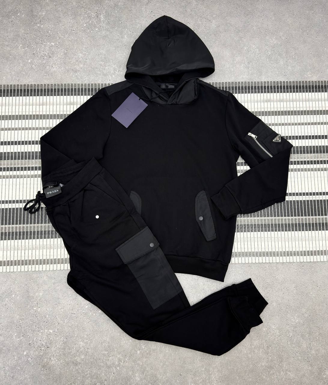 photo 5818804401542466811 y Prada Re-Nylon Details tracksuit 2 colours men's AAA replica UK - designer reps sale
