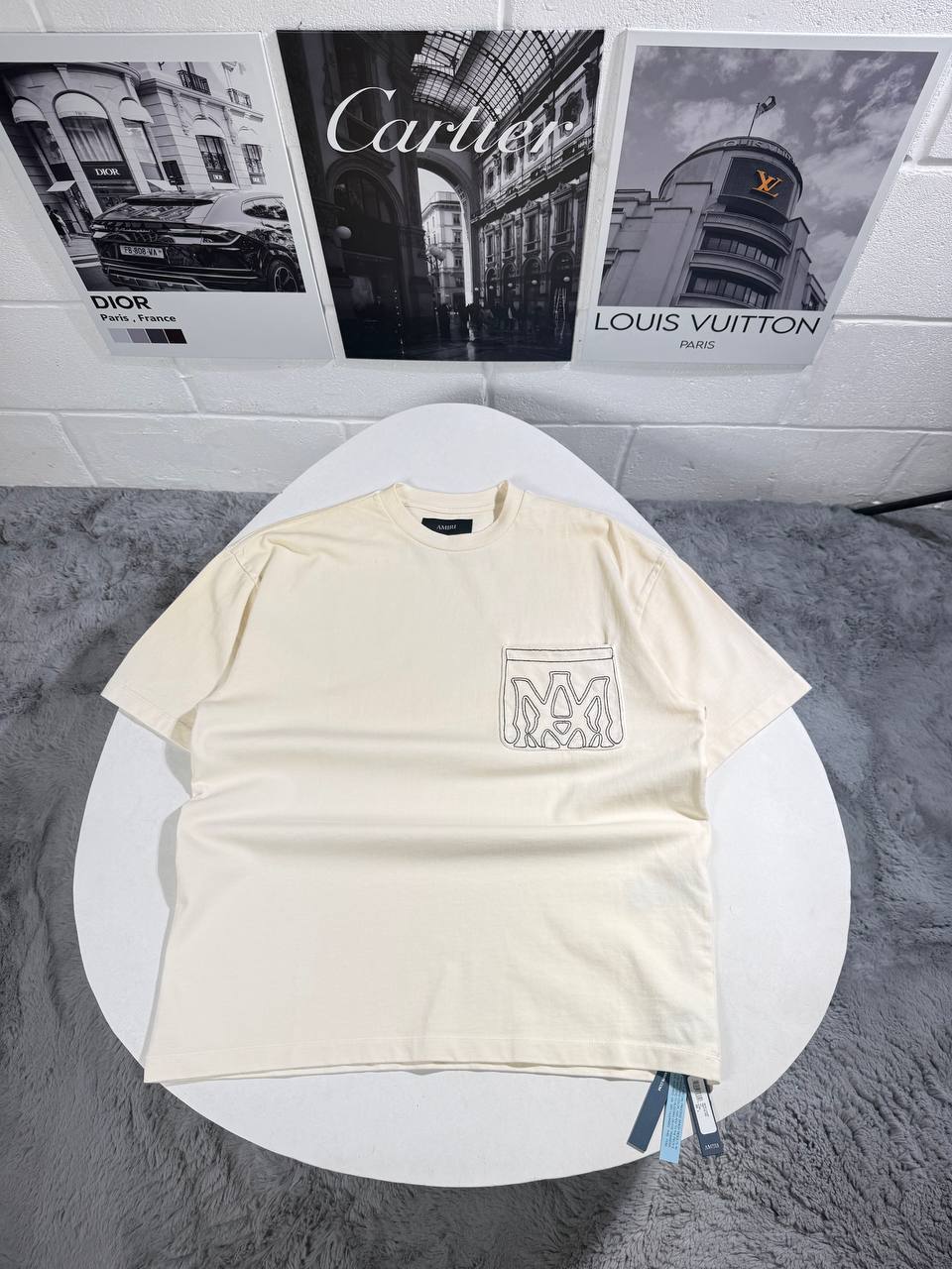 photo 5821087451538199285 y Amiri MA Outline pocket logo AAA replica t-shirt UK — men's women's 2 colours designer reps sale