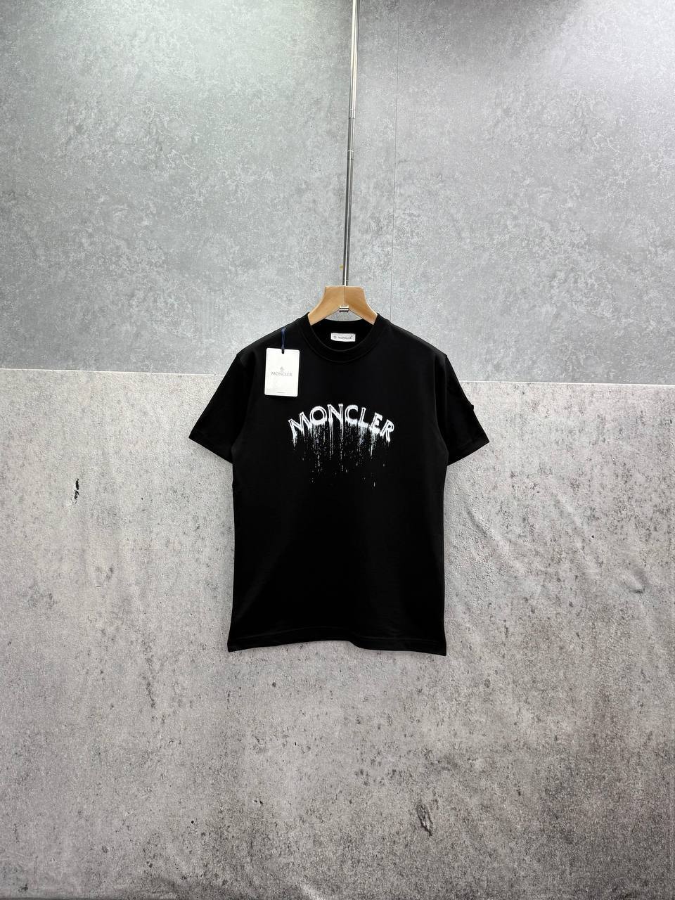photo 6010100960707332647 y Moncler Spray Arch Logo t-shirt AAA replica UK - men's women's 2 colours designer reps sale